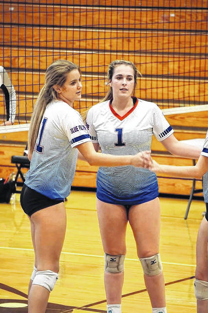 125856061_web1_picVB
Lady Blue Flame teammates Lauren Dow (right) and Caroline Lucas get ready for action during the tri-match in Anderson last week.
Photo by Lyndsay Earnhardt