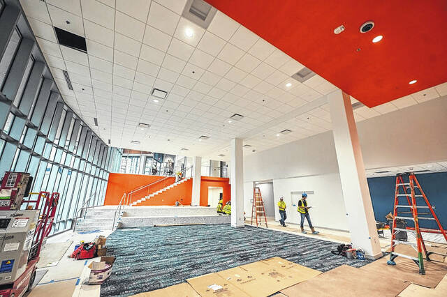 128797942_web1_atrium-1130x753
Workers put the finishing touches on the buildings ground floor, which will provide collaborative space for students between classes and flow seamlessly to outdoor seating areas.
Courtesy photo