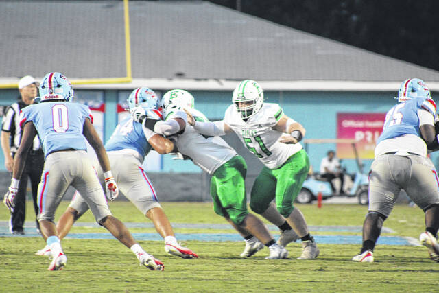Easley junior Cole Watkins (No. 51) looks for someone to block on Friday night. Watkins is also a standout wrestler for the green Wave.
                                 Jeff Holt | The Easley Progress