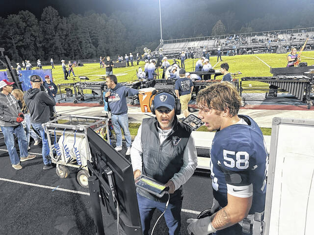 <p>Powdersville assistant coach Troy Gamble goes over film with senior offensive lineman Konnor Giles (No. 58) last Friday night in a 31-28 win over Christ Church Episcopal in overtime. </p>
<p>Jeff Holt | The Easley Progress</p>