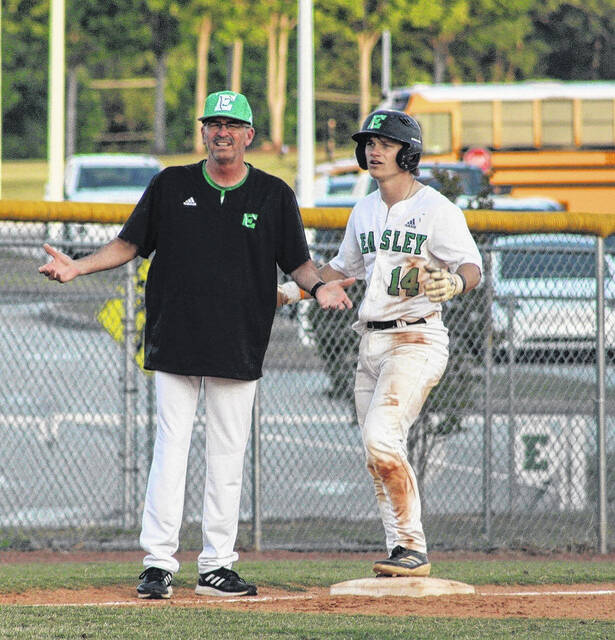 Easley High School baseball coach Gill Payne disputes a call from third-base last season with Aaron Tolbert standing on the bag.
                                 Photo Courtesy of Alicia Tolbert
