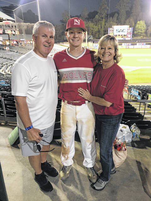 Pictured are Todd and his wife (Kim) with their son (Ben) at a game.
                                 Photo Submitted