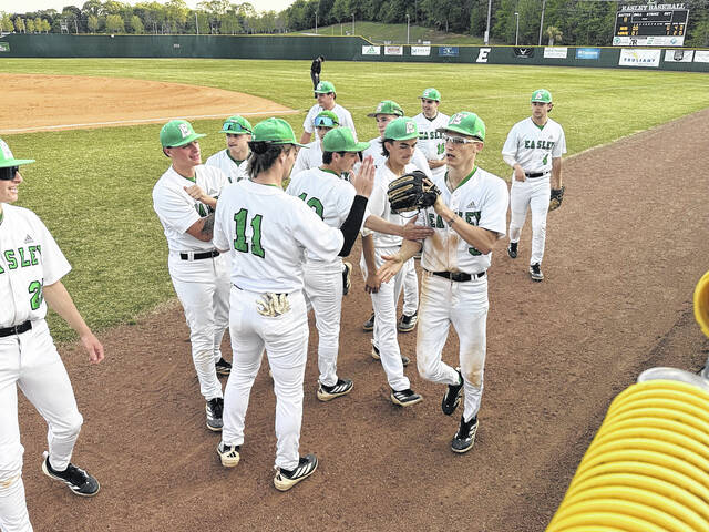 Easley centerfielder Trey Kicklighter is congratulated by his teammates after making one of the best catches of the season last week against Hillcrest. Kicklghter is a senior for the Green Wave.
                                 Jeff Holt / The Easley Progress